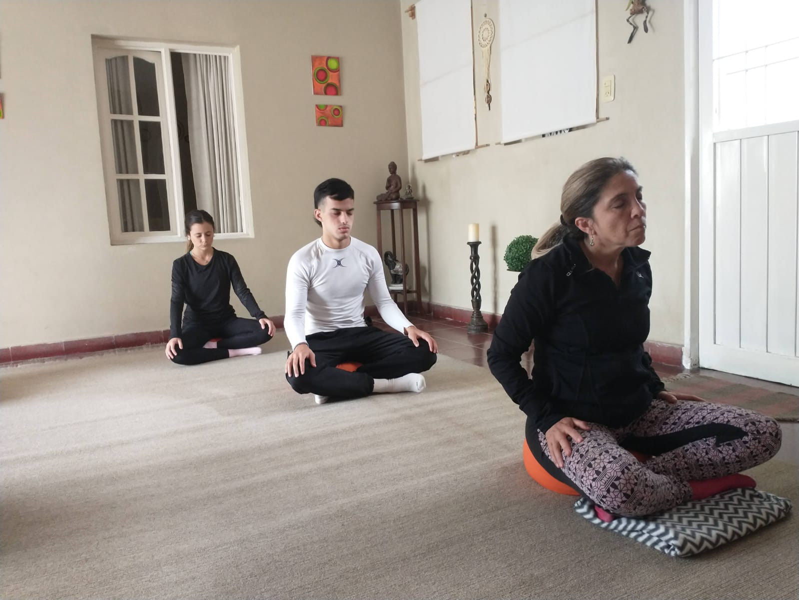 Un grupo meditando en el salón